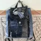 Sparkling mini backpack repurposed from old jeans creates signature piece for sustainable fashion enthusiasts, featuring unique drawstring design as distinctive fashion accessory and creative birthday gift.