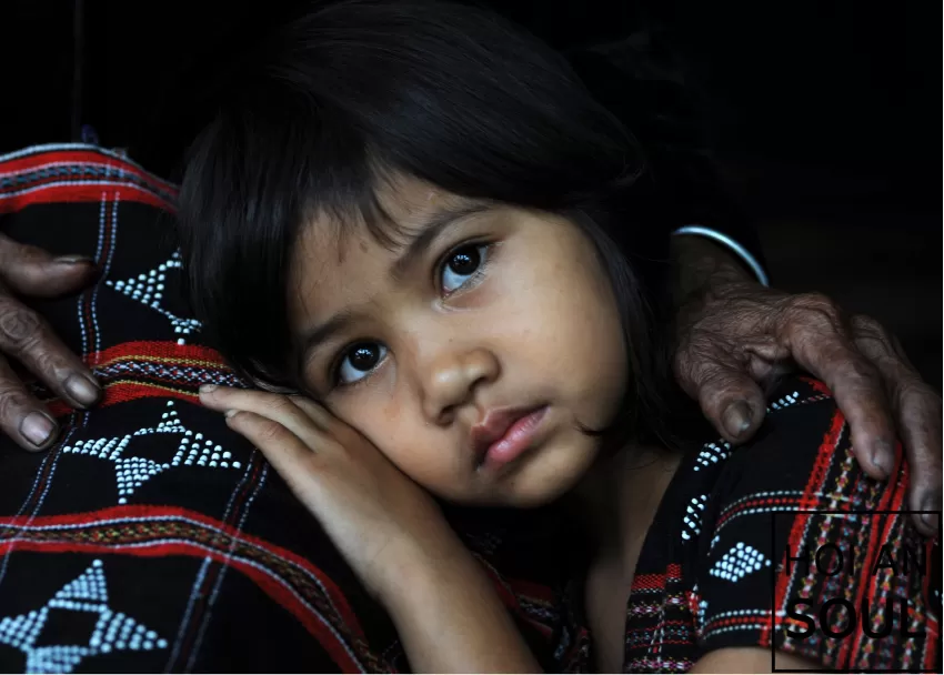 “In Grandma’s Arm” Photograph, A Photo Of A Co Tu Girl With Big Round Eyes, Evoking A Gentle And Warm Feeling