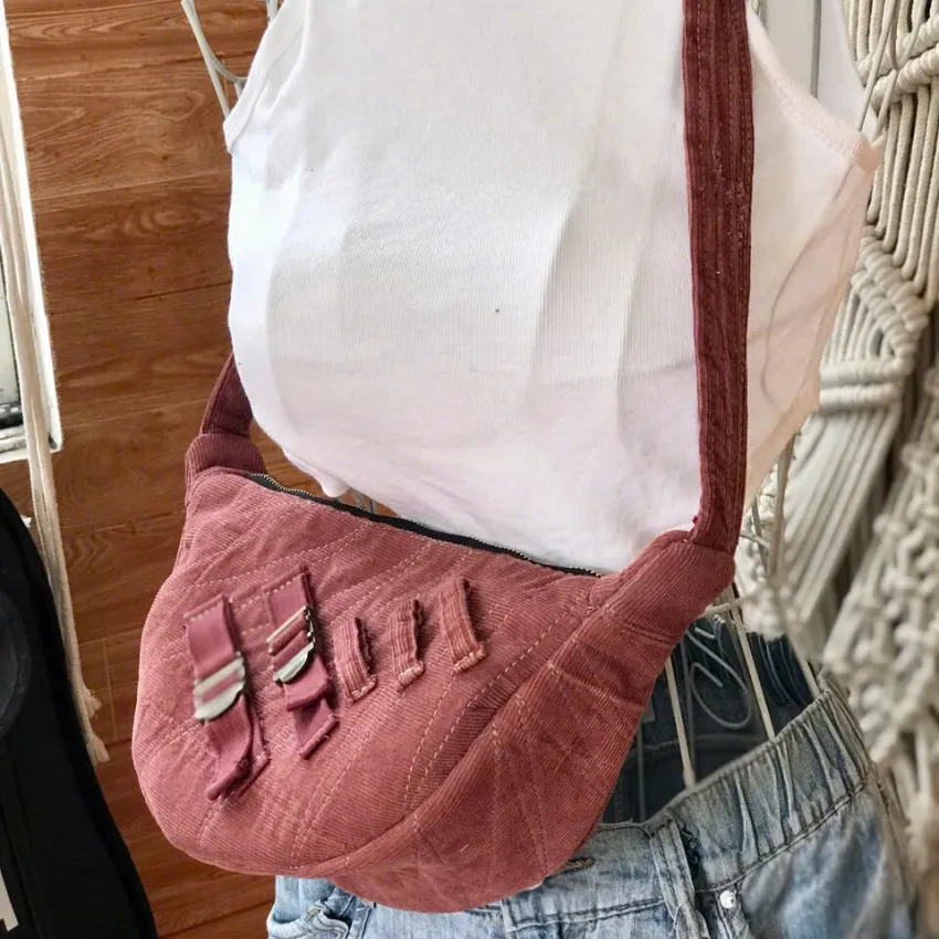 Dark pink half-moon crossbody bag from old jeans amplifying personal style, featuring premium upcycled jeans bag design as a creative birthday gift for sustainable fashion Dark pink half-moon crossbody bag from old jeans amplifying personal style, featuring premium upcycled jeans bag design as a creative birthday gift for sustainable fashion