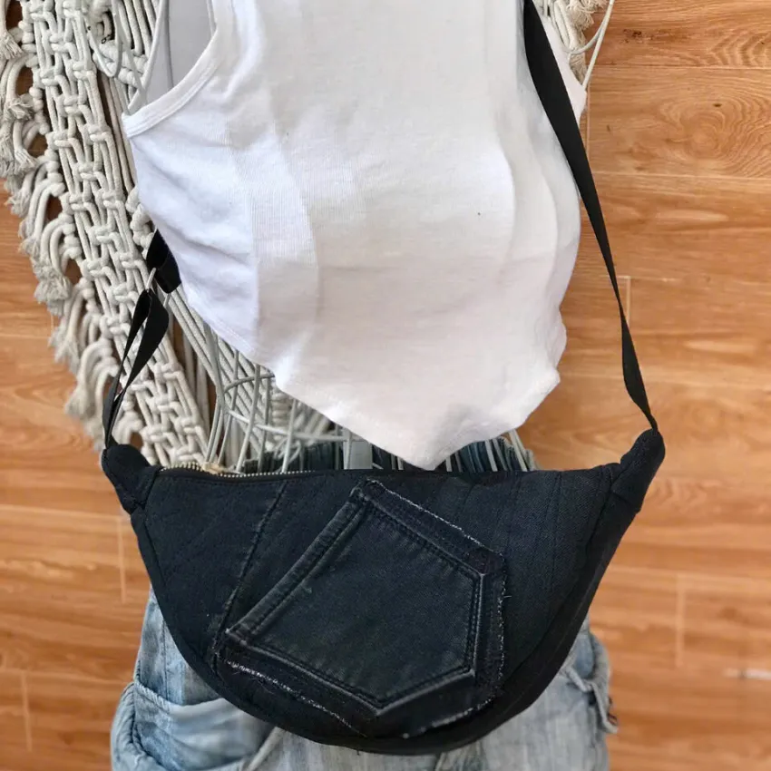 Black half-moon crossbody bag from old jeans adds a touch of mystery in every step, creating an upcycled accessory and unique gift for sustainable fashion enthusiasts Black half-moon crossbody bag from old jeans adds a touch of mystery in every step, creating an upcycled accessory and unique gift for sustainable fashion enthusiasts