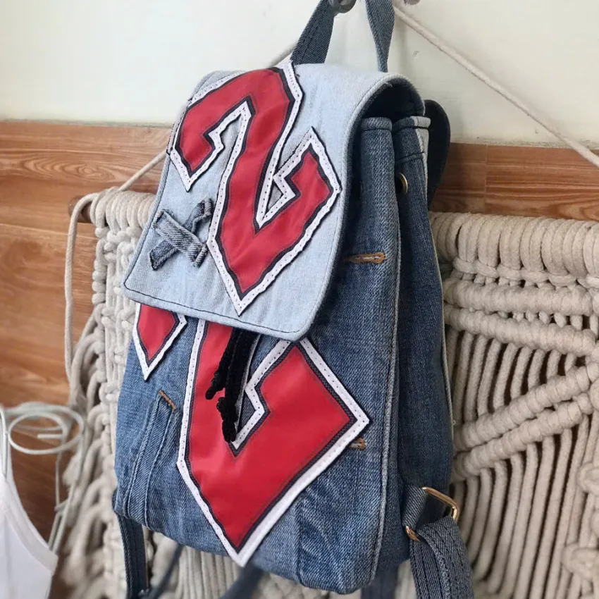 Mini number 2 backpack from upcycled jeans with explosive personal style, a handcrafted accessory making an impressive and unique birthday gift. Mini number 2 backpack from upcycled jeans with explosive personal style, a handcrafted accessory making an impressive and unique birthday gift.