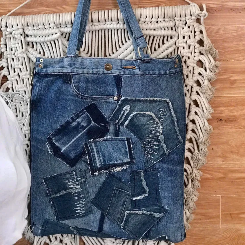 Slim bottom tote crafted from old jeans creates an exclusively yours accessory, combining upcycled materials with fashion-forward design as sustainable fashion statement and meaningful eco-friendly handmade gift Slim bottom tote crafted from old jeans creates an exclusively yours accessory, combining upcycled materials with fashion-forward design as sustainable fashion statement and meaningful eco-friendly handmade gift