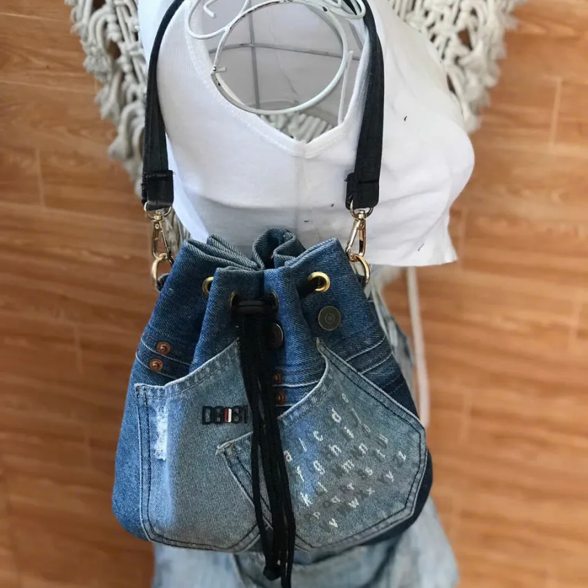 Blue printed letter bucket bag from old jeans with passion infused in every detail, creating an upcycled convenient drawstring bag and impressive birthday gift Blue printed letter bucket bag from old jeans with passion infused in every detail, creating an upcycled convenient drawstring bag and impressive birthday gift