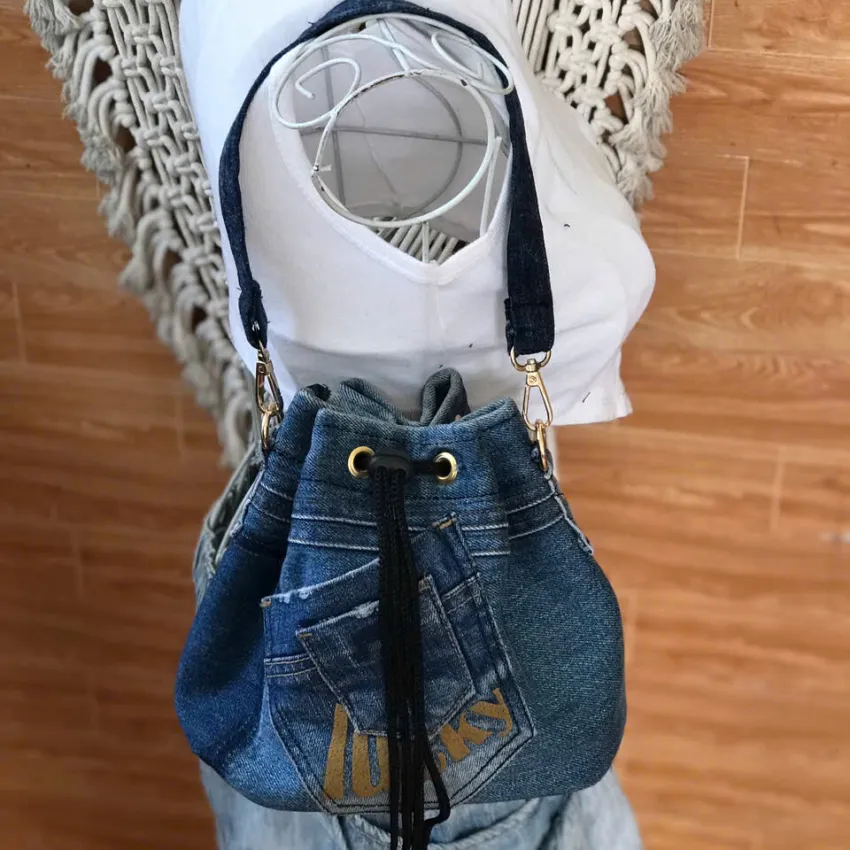 7LUCKY bucket bag from old jeans serves as companion for dynamic days, featuring drawstring design as upcycled jeans accessory and creative handcrafted birthday gift. 7LUCKY bucket bag from old jeans serves as companion for dynamic days, featuring drawstring design as upcycled jeans accessory and creative handcrafted birthday gift.