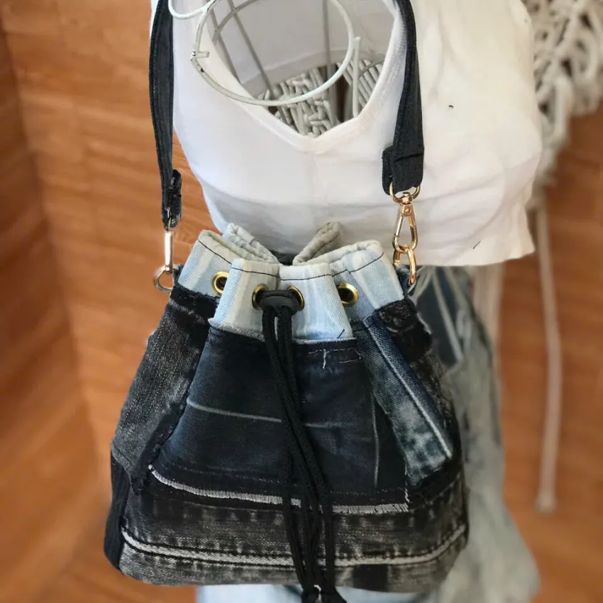 Gray and black bucket bag from old jeans features signature mark on every line, creating a jeans handbag as sustainable fashion accessory for impressive birthday gift and handcrafted gift Gray and black bucket bag from old jeans features signature mark on every line, creating a jeans handbag as sustainable fashion accessory for impressive birthday gift and handcrafted gift