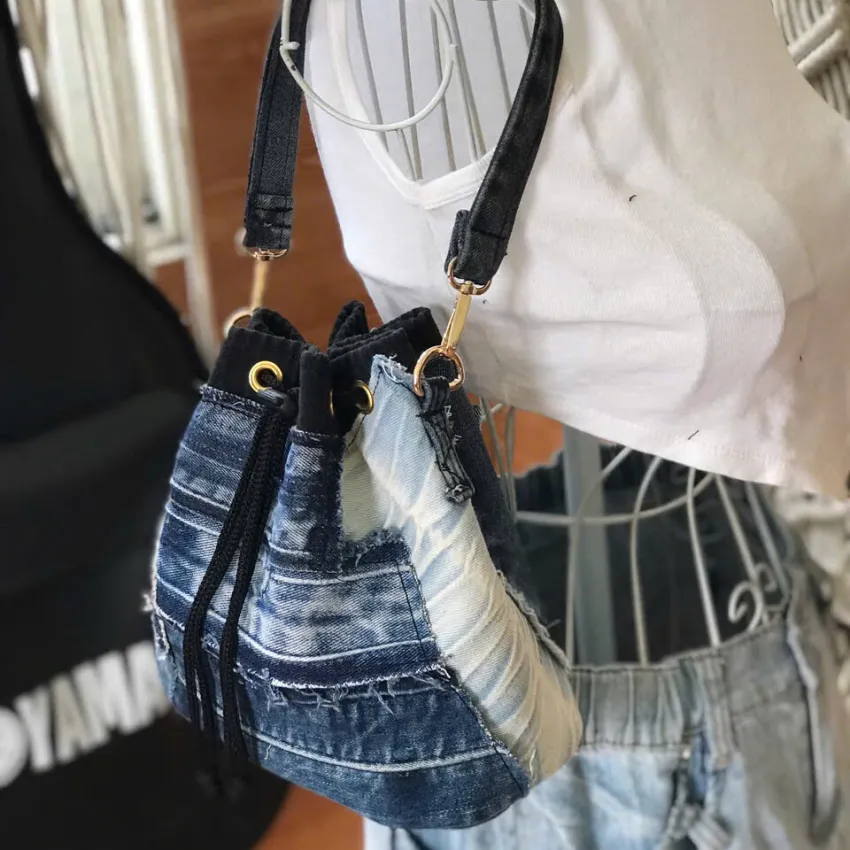 Blue-accented bucket bag from old jeans makes sustainable fashion's bold statement with convenient drawstring design, creating an upcycled jeans bag and creative birthday gift Blue-accented bucket bag from old jeans makes sustainable fashion's bold statement with convenient drawstring design, creating an upcycled jeans bag and creative birthday gift