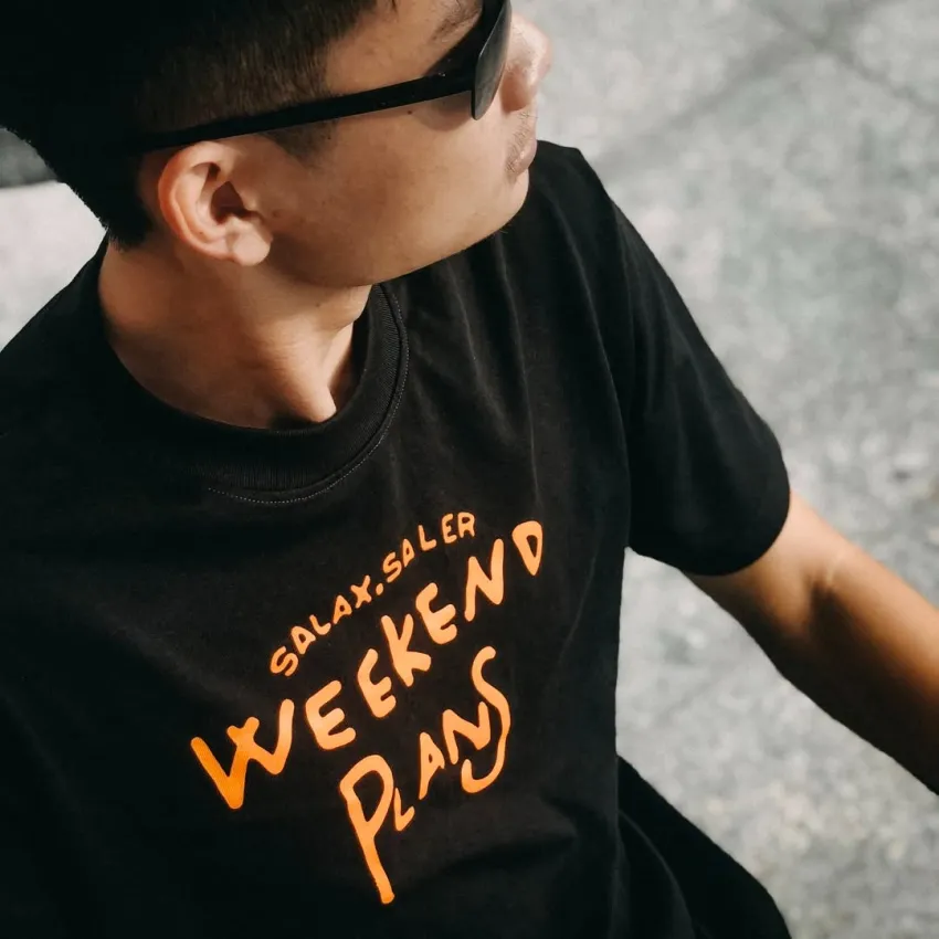 "Weekend Plans" cotton T-shirt with energetic graphics, celebrating your own time and space—designer streetwear with unique style, perfect as a birthday gift or Vietnamese souvenir
